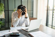 © Charlie's - Asian Business man tiredness and stress while having headache. Painful men are stressed at work in office