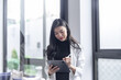 © Charlie's - Beautiful asian doctor Education profession doctor in white uniform gown coat Professional medical doctor with tablet at seminar or hospital wellness center