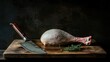 © Mika - Fresh poultry leg with skin on displayed on wooden cutting board alongside a sharp kitchen knife and fresh herbs in a rustic dark setting