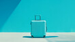 © Sadia - Stylish turquoise suitcase against a blue background in bright daylight