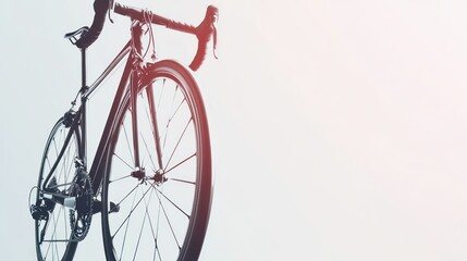 A close-up of a bicycle against a light background, emphasizing its design and structure.