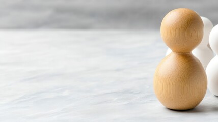 Wooden figure among white figures, symbolizing diversity and inclusion