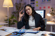 © Phimwilai - Stressed asian businesswoman holding a pen and having a headache while analyzing financial paperwork and working late at night in office, overworked employee and overworking concept