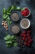 © DreamPointArt - Fresh superfoods spread featuring chia seed puddings with omegas, almonds, raspberries, and fresh herbs for nutrient-rich snacks