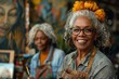 © Vilaysack - A joyful elderly woman with gray hair and flowers smiles at the camera, while another artist works in the background, surrounded by vibrant artwork.