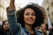 © Fabio - Female activist raising her fist at a rally, symbolizing justice and equality