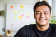 © Centric  - Portrait of a young latin businessman smiling in his office with notes on whiteboard, concept of startup, entrepreneurship and business