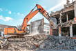 © Anoo - Excavator clears debris from industrial building demolition under a sunny blue sky