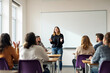 © Pixels Hunter - Woman leading a discussion in a classroom setting with attentive students, light background, concept of teamwork and education.