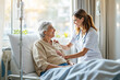 © Pixels Hunter - Nurse providing compassionate care to a smiling elderly patient in a hospital room.