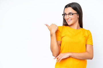 Wall Mural - Young caucasian woman isolated on white background pointing to the side to present a product