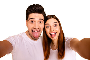 Wall Mural - Self-portrait of his he her she two nice attractive lovely stylish cheerful cheery comic playful people husband wife showing tongue out isolated over vivid shine bright yellow background