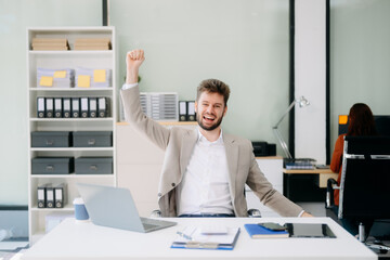 Young business man working at office with laptop, tablet and taking notes