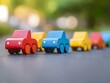 © Momina - Colorful wooden toy vehicles lined up on a smooth surface