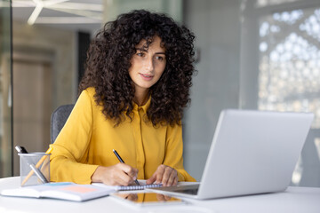 woman at workplace watching training video course webinar, office worker writing training data in no