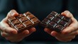 © Formoney - Two people holding two pieces of chocolate