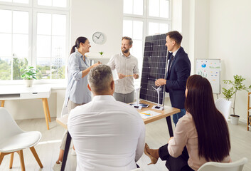 Office team participates in a group presentation focused on solar panels and renewable energy. The discussion highlights alternative power sources and the importance of sustainable energy solutions.