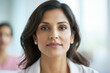 © Aleksandra - Confident Young Hispanic Female Professional in Bright Office Setting