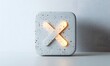 © Maryanto - Glowing X mark on textured square button.