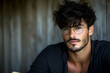 © Putu - Handsome man with dark hair and round glasses, serious expression, close-up portrait against a blurred wooden background.