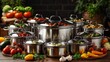 © AGUNG - Stainless steel cookware set with various lids and food inside.