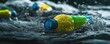 © Maftuh - Plastic Pollution Crisis: Colorful Bottles in Murky Water, Environmental Concern