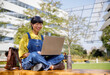 © Jovo Jovanovic/Stocksy - Asian woman working on laptop in college campus
