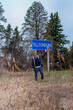 © tessy morelli/Stocksy - Man standing by City sign of Tillsonburg, Ontario, Canada