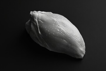 Wall Mural - a unique abstract representation of a smooth white shape resting against a dark backdrop. this image