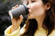 © Oleksii Syrotkin/Stocksy - Partial profile of thoughtful asian woman drinking coffee from cup