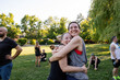© Rob and Julia Campbell/Stocksy - Happy People Hugging Outdoors in Community Park