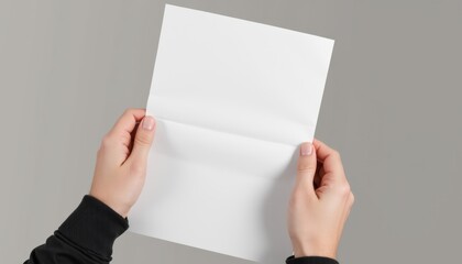 Fototapete - Realistic A4 paper mockup held in hands, slightly bent to reveal texture, soft natural light, neutral background