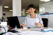 © Jovo Jovanovic/Stocksy - Young businesswoman working at desk in office