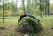 © Yana Bulgakova/Stocksy - Girl lying on the rock
