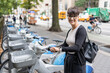 © Alvaro Lavin/Stocksy - Businesswoman renting electric scooter in new york city