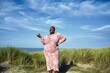 © Studio Sincère/Stocksy - Joyful woman poses with a fruit on a sunny beach