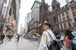 © Alvaro Lavin/Stocksy - Tourist walking and admiring fifth avenue in manhattan, new york city