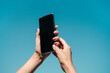 © Lucas Ottone/Stocksy - Woman's hands holding phone