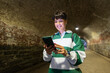 © Alvaro Lavin/Stocksy - Smiling tourist using smartphone in a tunnel in manhattan