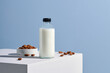 © Marc Tran/Stocksy - Almond milk in glass with almonds