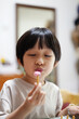 © ChaoShu Li/Stocksy - Closeup of an Asian boy playing with handicrafts at home