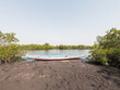 © Alvaro Lavin/Stocksy - Colorful wooden pirogue resting on riverbank in delta saloum, senegal