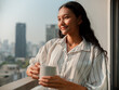 © Marija Savic/Stocksy - Woman Enjoying Morning Coffee on a City Balcony