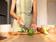 © Marija Savic/Stocksy - Woman Preparing Healthy Salad with Fresh Vegetables in Kitchen