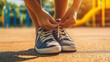 © MarGa - Hispanic child tying shoelaces on sneakers in a sunny playground, symbolizing independence and back-to-school readiness