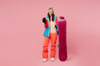 © ViDi Studio - Full body young woman wear warm blue jacket ski goggles mask spend weekend winter season in mountains hold snowboard use blank screen mobile cell phone isolated on plain pink background Hobby concept