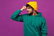 © ViDi Studio - Young sad exhausted sick ill weary Indian man he wear green hoody yellow hat casual clothes keep eyes closed rub put hand on nose isolated on plain purple background studio portrait Lifestyle concept