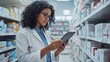 © AlfaSmart - Pharmacist using tablet in a modern pharmacy.  Efficient and focused work environment.