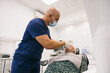 © VICTOR TORRES/Stocksy - Dentist Attends to Patient in Modern Dental Clinic Setting