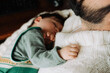 © Olga Moreira/Stocksy - Close-up of childâs hand resting on fatherâs sweater during